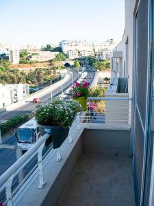 a balcony with two potted plants and a street at Couple's Getaway in Is-Swieqi