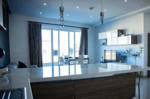 a kitchen with a large white island in a room at Couple's Getaway in Is-Swieqi