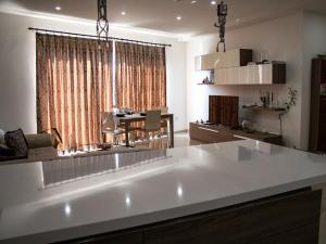 a kitchen with a large white island in a room at Couple's Getaway in Is-Swieqi