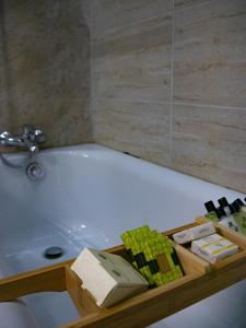 a bathroom with a bath tub with a tray of soap at Couple's Getaway in Is-Swieqi