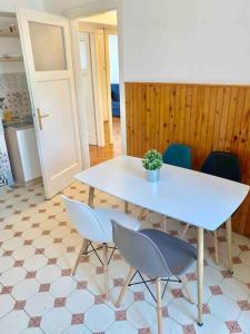a white table and chairs with a potted plant on it at Split City Center Apartment in Split