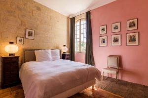 a bedroom with a large bed and a window at Le domaine des Oréades in Uzès