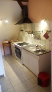 a kitchen with a sink and a stove at Gîte Yves in Wihr-au-Val