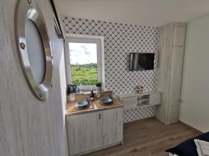 a small kitchen with a sink and a window at Surf camp in Krynica Morska +65 photos