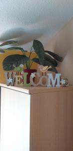 a shelf with a sign that says plant on it at Andi Apartman in Gyula