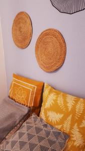 a wall with two baskets and pillows on a wall at Studio S. Lourenço in Lisbon