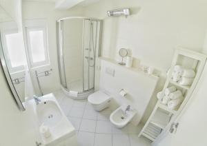 a bathroom with a toilet, sink, and shower at Apartments & Rooms Barbati in Novalja