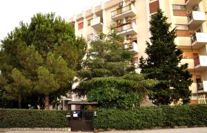 an apartment building with trees in front of it at Casa Rosetta in Palermo