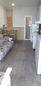 a room with two beds and a table and a kitchen at Apartment Moe More in Odesa
