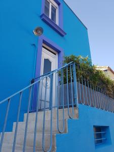 a blue building with stairs and a window at La Maison Bleue in Rezé