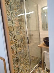 a shower in a bathroom with a cross on the wall at les lilas in Ozoir-la-Ferrière +10 photos