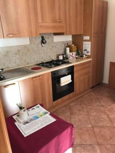 a kitchen with a stove and a table in it at Dolomites Charme Chalet in Colle Santa Lucia