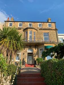 a large brick house with a staircase in front of it at Savoy in Fleetwood