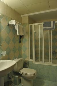 a bathroom with a toilet and a sink at Hotel Katerina in Athens