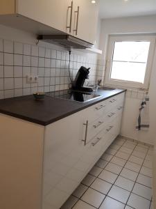 a kitchen with a black counter top and a sink at Ferienappartement Jung in Kamp-Lintfort