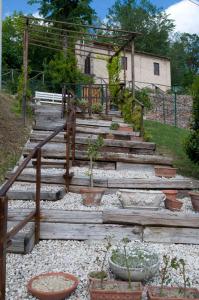a set of wooden stairs with potted plants at Casa della Strega in Montegiorgio