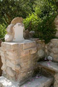a stone wall with a water hydrant on it at Casa della Strega in Montegiorgio