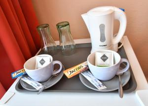 a tray with two coffee cups and a blender at Hotel Golf Ostrava Silherovice in Šilheřovice