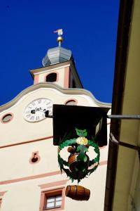 un bâtiment avec une tour d'horloge et une horloge dans l'établissement Hotel Gasthof Prunner, à Gmünd in Kärnten