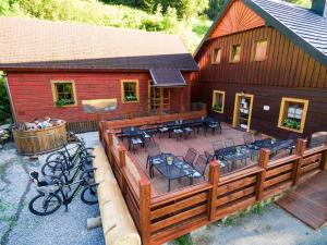 a large deck with chairs and tables on a cabin at Chata Magurka in Partizánska ľupča