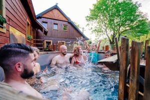 a group of people playing in a hot tub at Chata Magurka in Magurka