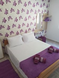 a bedroom with a bed with two teddy bears on it at Bestie House in Kotor