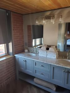 a bathroom with two sinks and a large mirror at The Hotel Sturgis in Sturgis