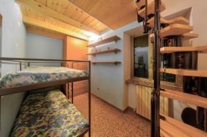 a small room with two bunk beds and a window at Casa Tinin in Loano +2 photos