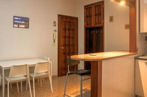 a kitchen with a table and chairs in a room at Casa Tinin in Loano