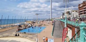 people walking on a pier near the beach at Andorra Guest Accommodation in Brighton & Hove