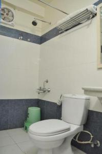 a bathroom with a white toilet and a sink at Hotel Savoy - Since 1951 in Jaipur