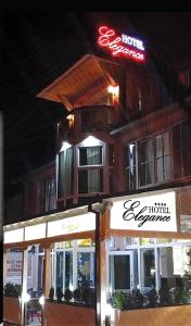 a building with a neon sign on top of it at Hotel Elegance in Sarajevo