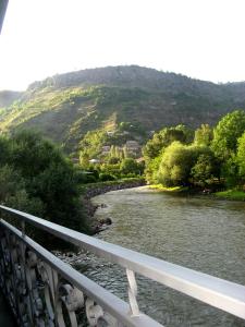 a bridge over a river with a mountain in the background at NEW SANAHIN in Alaverdi