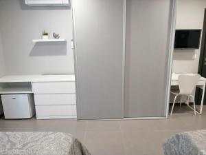 a bedroom with a sliding glass door with a desk at Anevan in Vidago