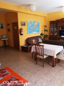 費斯特拉的住宿－Albergue Por Fin，客厅配有桌子和沙发