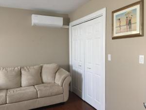 a living room with a couch and a white door at Seaview White House in Stratford