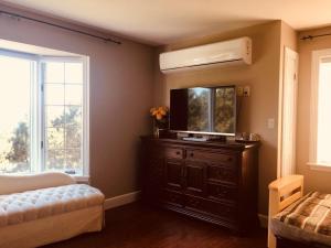 a bedroom with a bed and a dresser with a mirror at Seaview White House in Stratford
