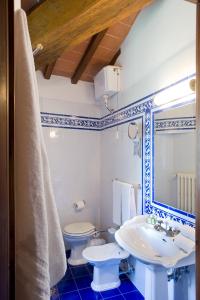 a bathroom with a toilet, sink, and bathtub at Villa Campestri Olive Oil Resort in Vicchio