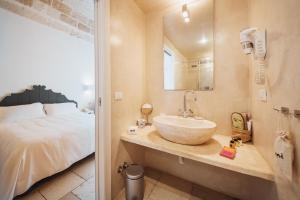 a bathroom with a sink and a bed at Giovì Relais in Polignano a Mare