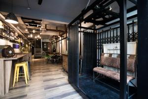 a room with a bar and a table with chairs at The Brick in Tainan