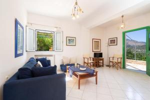 a living room with a blue couch and a table at Anna's Apartment near Agia Efimia & Myrtos beach in Pilaroú