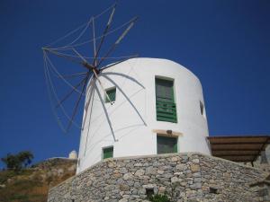 a windmill on top of a stone building at Anemos Studios in Panteli