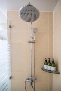 a shower with a shower head in a bathroom at Breeze Bay Hotel in Seogwipo