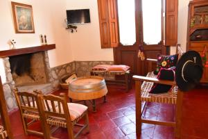a living room with a table and chairs and a fireplace at Balcones de San Carlos - casa Balcones in Cafayate