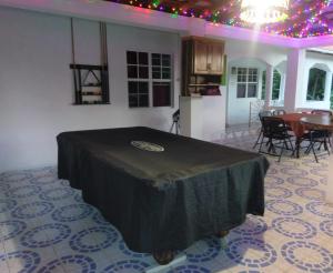 a living room with a table and a dining room at Polish Princess Guest House in Port Antonio