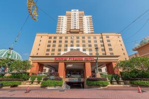 a large building with a restaurant in front of it at Resort Suites @ Sunway Pyramid & Sunway Lagoon in Petaling Jaya