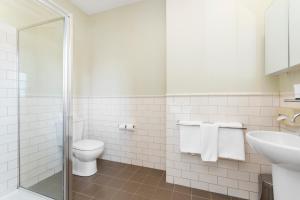 a bathroom with a toilet and a sink at Launceston Central Apartment Hotel Official in Launceston