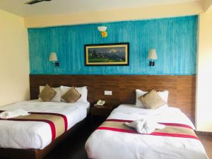 En eller flere senger på et rom på Hotel Guru
