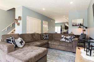 a living room with a couch and a dining room at Mountain House in Edmonton