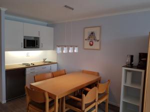 a kitchen with a wooden table and chairs in a room at Family Appartment in Sankt Englmar